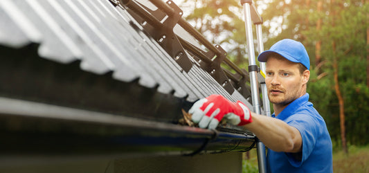 contractor cleaning a half round gutter 