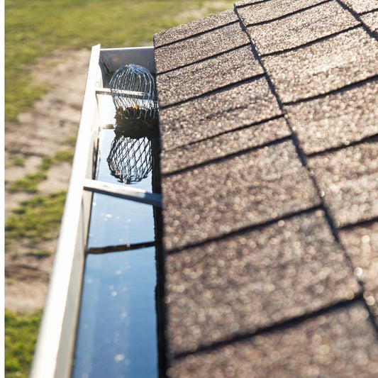 clogged wire basket downspout strainer and overflowing gutter