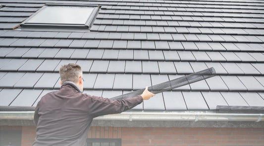 Installer installs gutter guards, as found at Menards