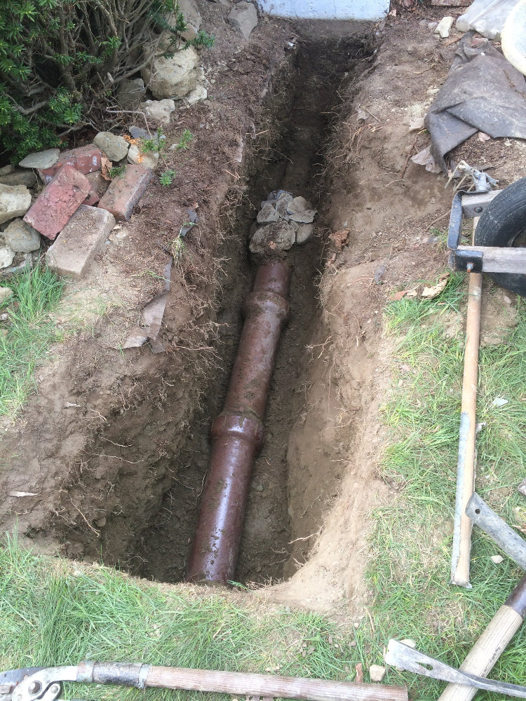 Buried gutter downspout drainage pipe needs to be excavated because it is clogged.