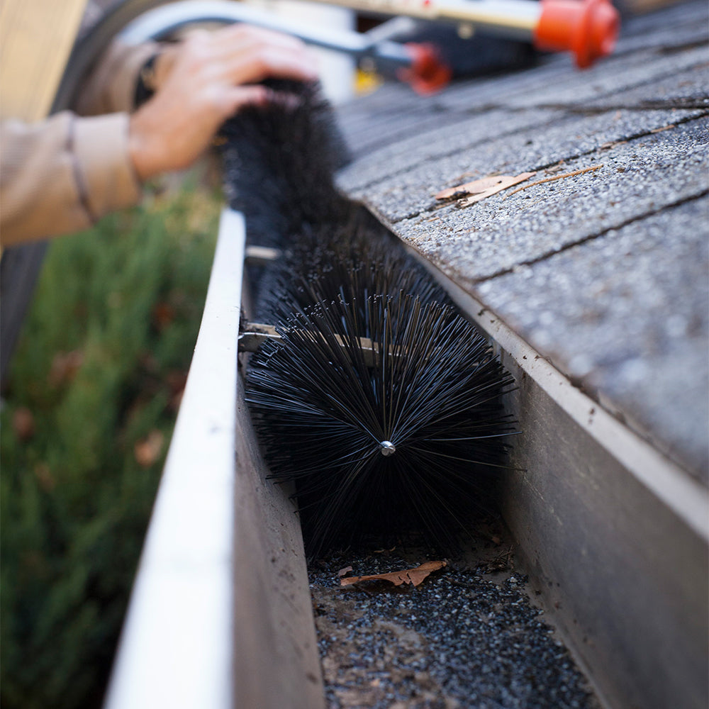 Brush gutter guard inserted into gutter by installer