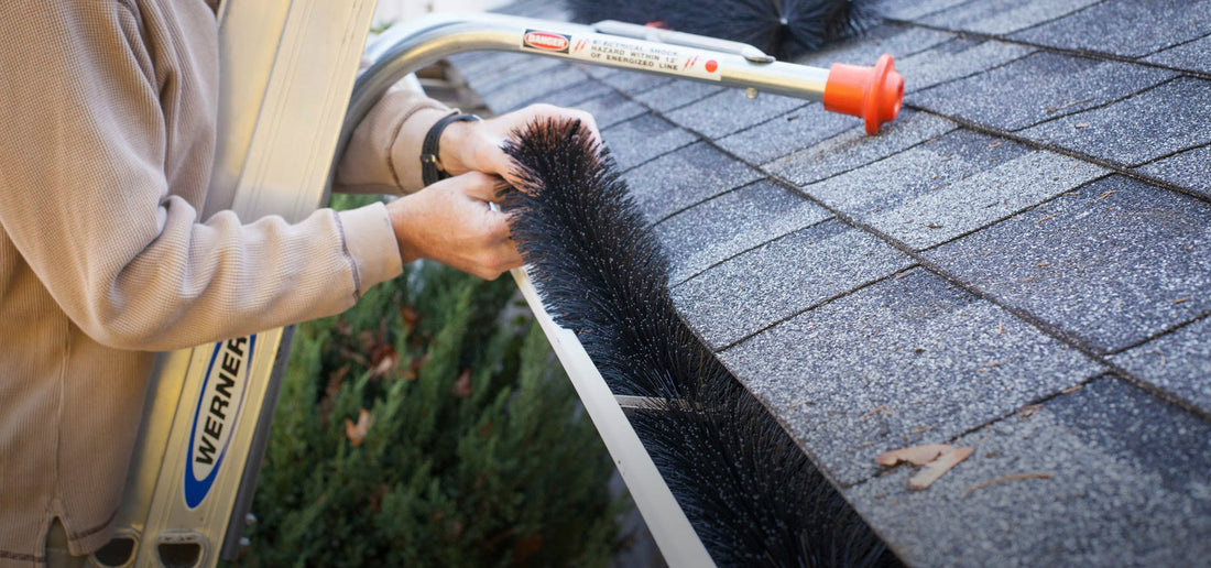 lady installs gutter clog protection