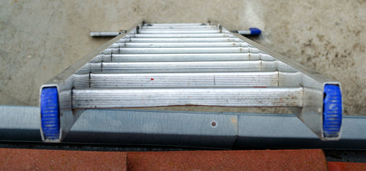 steep ladder leaning on gutter
