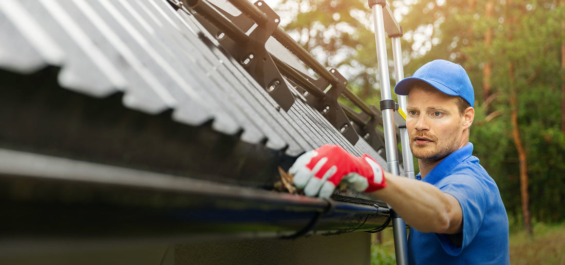 contractor cleaning a half round gutter 