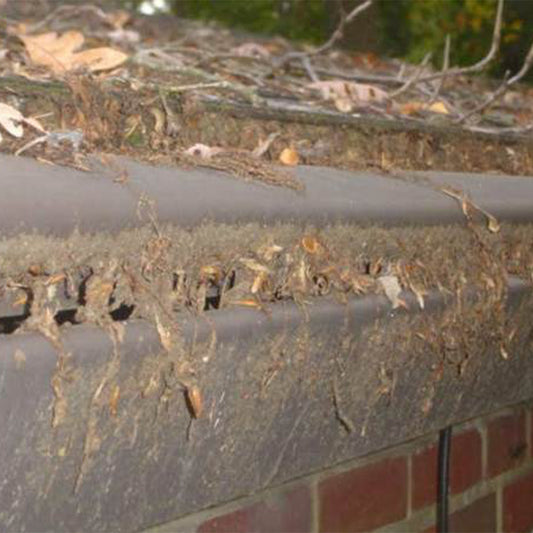 debris filled clogged gutter helmet style gutter cover