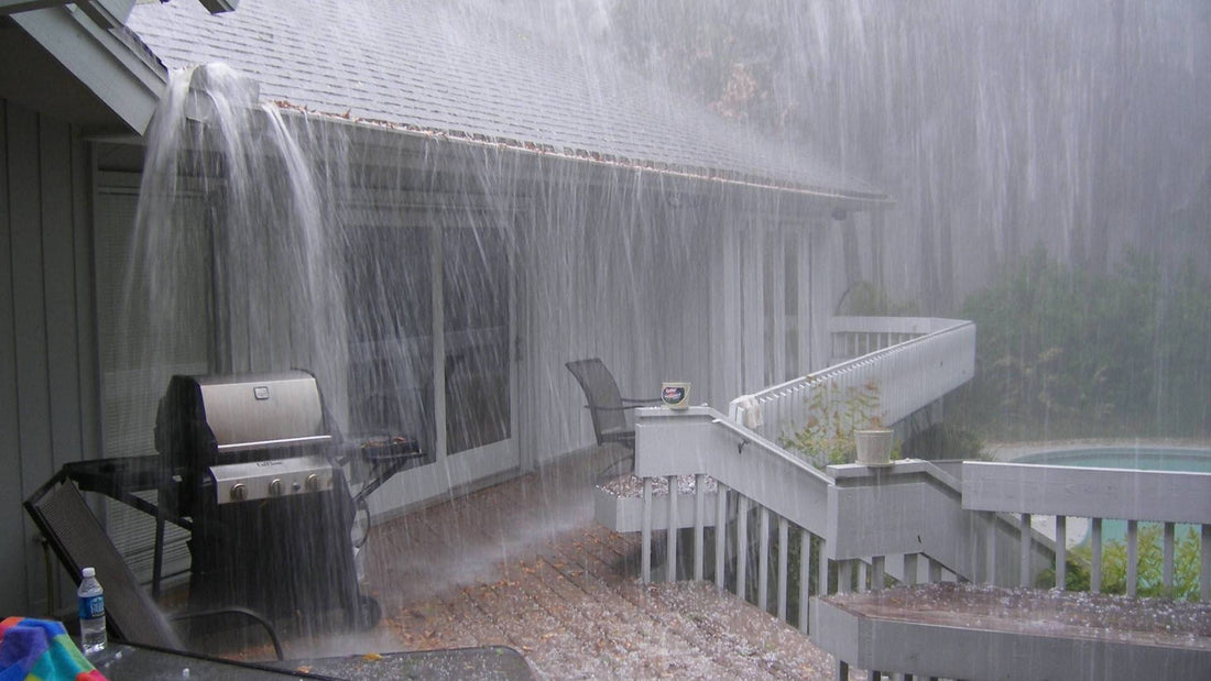 heavy rain pours down roof overshooting gutter