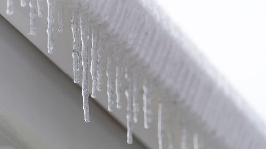 icicles hanging from a frozen rain gutter that does not have a electric ice melting cable