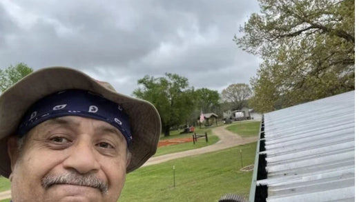 Man on a ladder evaluating his leaf filter to write a gutter protection review.